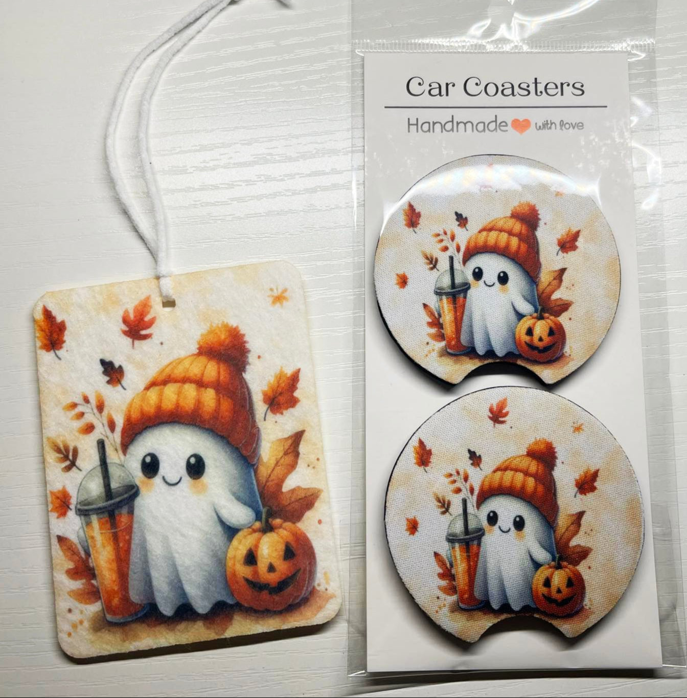 Car coasters with ghost and pumpkin design in packaging on a white background