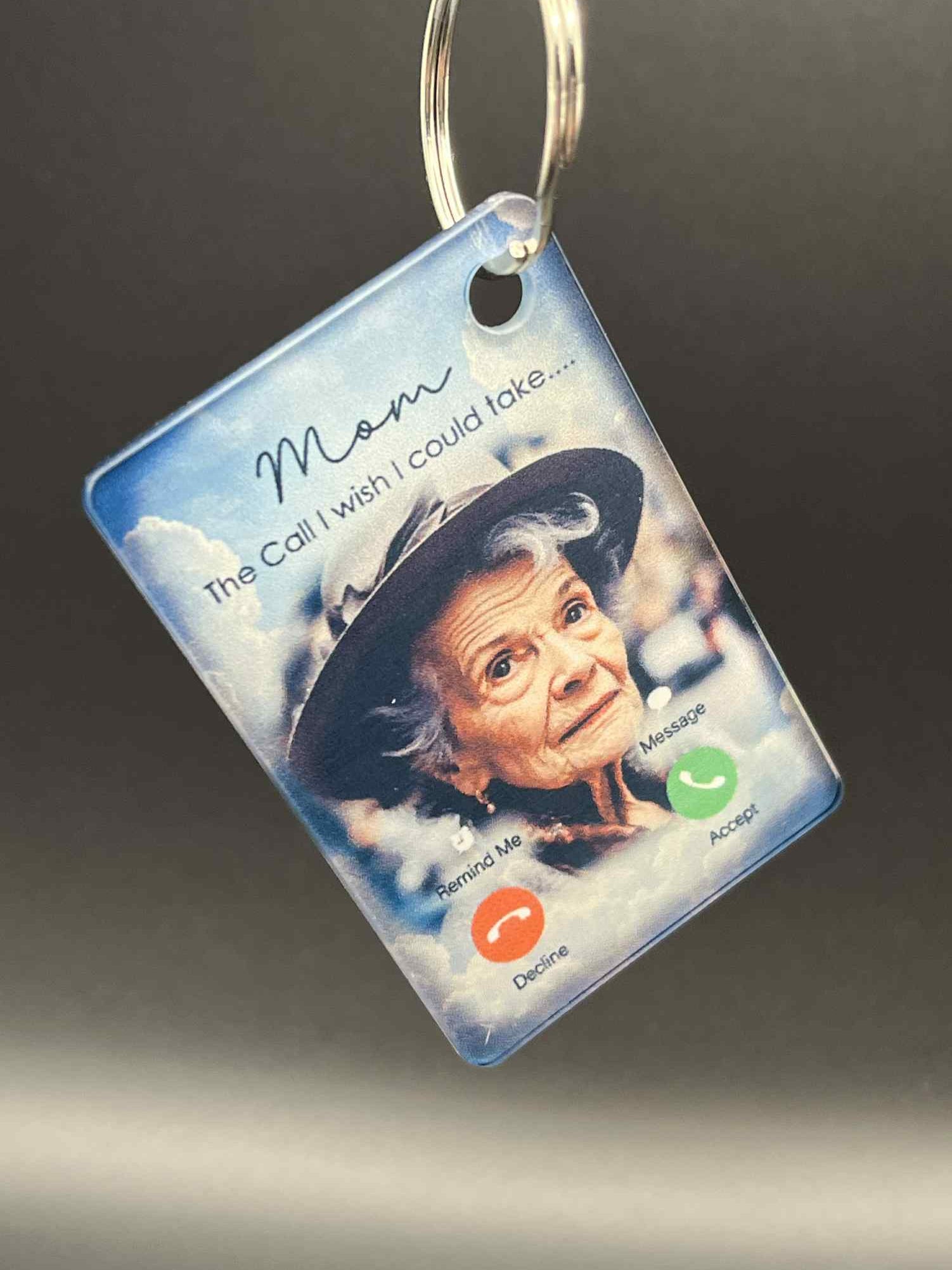 Keychain with a photo of an elderly woman and text on a dark background